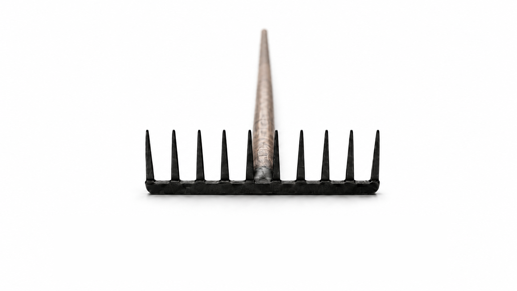 A black garden rake seen head-on, its handle receding into white space